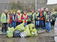 Dodging hailstorms to clean up village