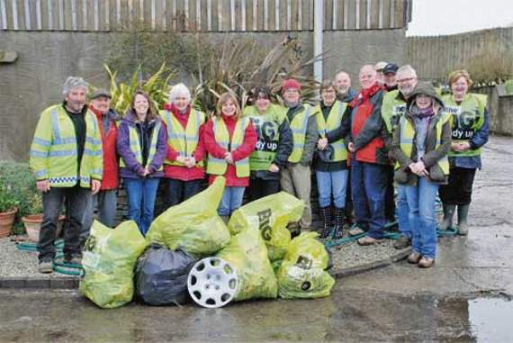 Dodging hailstorms to clean up village