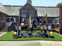 Students show off their climbing skills on new play equipment