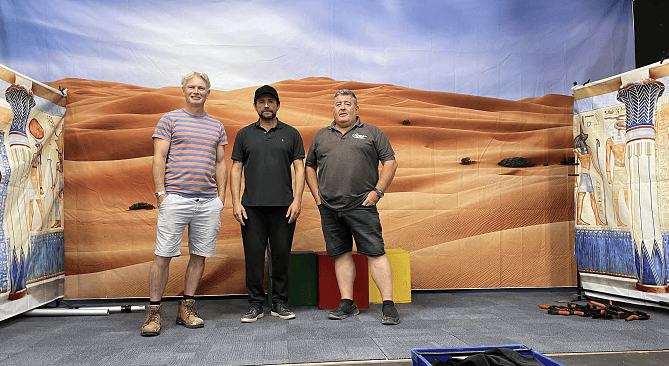 Robin Askwith, Tony, and Mark Williams on the stage set for Bodmin musical theatre group