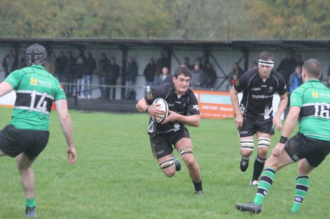 Flanker George Bone, pictured running at the Drybrook defence last season, returns to the side on Saturday.