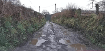 Community fight for repairs to 'dire' road littered with potholes