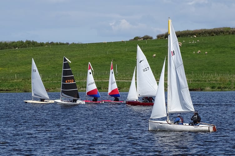 The start of the second race with Nathan Pollard first over the line in his full rig Laser followed by a Solo, two Toppers and two Bosuns.