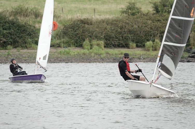 Dave Perrett's Solo with a full-sized sail leads Jane Anderson's Laser flying its smallest sail. Applying the handicaps reversed their positions. Picture: Mandy Pollard