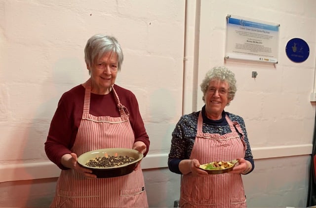 Coad’s Green Cooks pose their question for the last time — Pat Mallett, left, and Alison Gribble, right, pictured at their penultimate ‘Trolley’ demonstration in April 2023