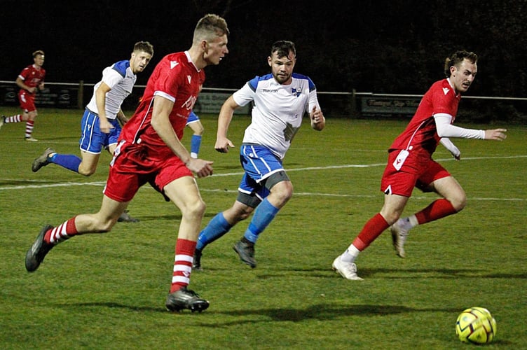 Bude's man of the match Tom Davey breaks with the impressive Ruan Tape looking to make a run. Camelford's Ross Beare is on the cover with captain Sam Wade in the background. Picture: Chris Pointer