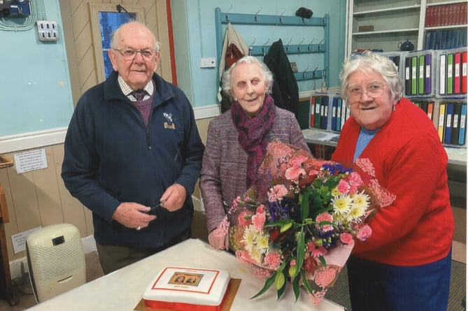 Vera Ellacott presenting Evelyn Sandercock with a bouquet with Viv looking on at a recent meeting of Launceston Stamp Club when Evelyn stepped down from being secretary after serving for 35 years