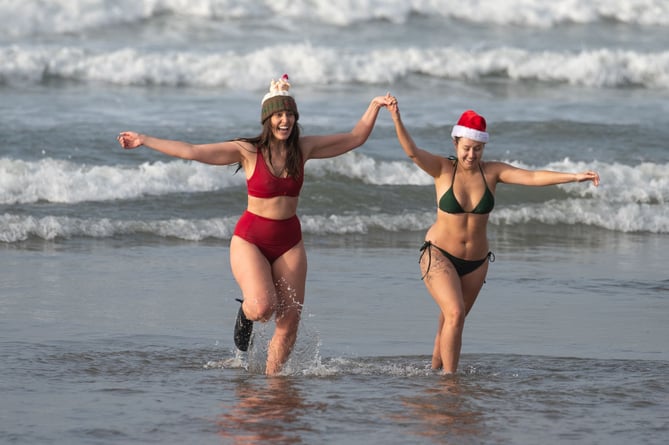 Bude Christmas Day Swim 2024. Swimmers gather for the annual Christmas Day dip at Crooklets Beach in Bude, Cornwall. Mark Theisinger 07976 918112