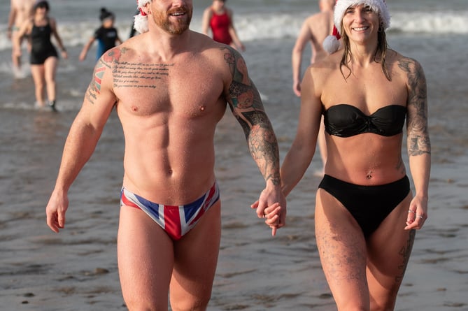 Bude Christmas Day Swim 2024. Swimmers gather for the annual Christmas Day dip at Crooklets Beach in Bude, Cornwall. Mark Theisinger 07976 918112