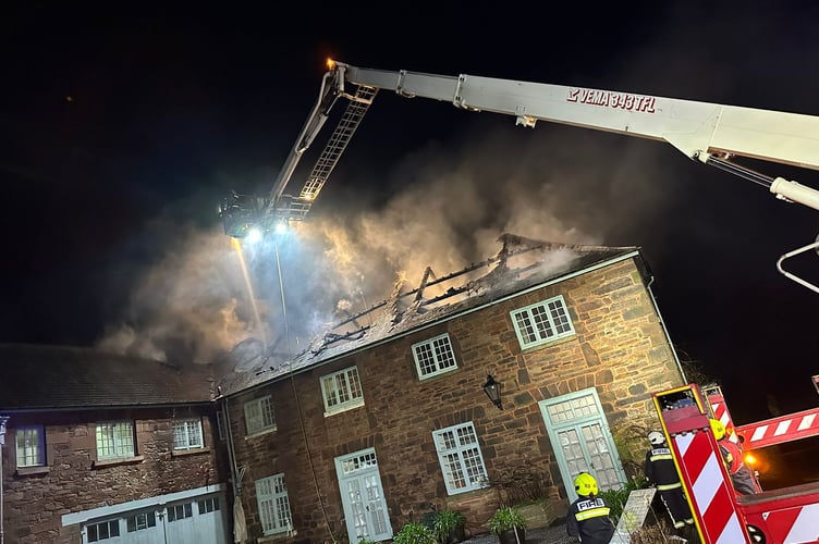 An aerial ladder in operation at the scene of the fire on the Mount Edgcumbe Estate