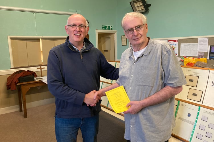 Launceston Stamp Club chairman Barry Mudie presenting a certificate of the club's appreciation to the speaker for the evening Bob Wheeler from Totnes